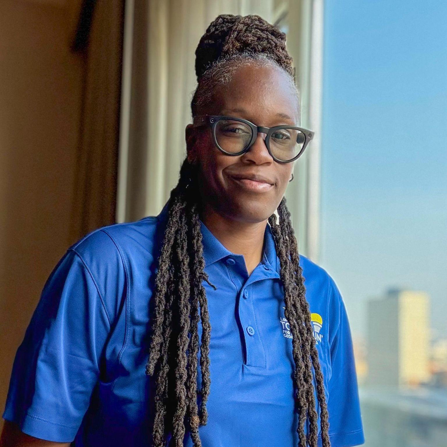 Carlai Moore, founder of Tables and Bridges, in a professional field portrait.